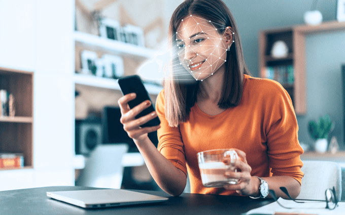 Woman scanning face biometrics with cellphone