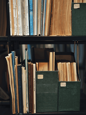 A bookshelf with old files and papers